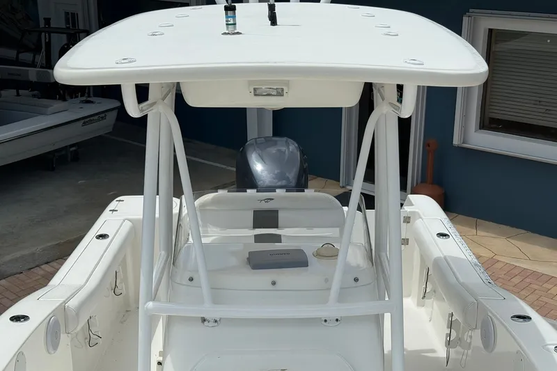 Slide: The Image of 2013 Tidewater 230 CC Adventure boat with T-top and outboard motor. - 20