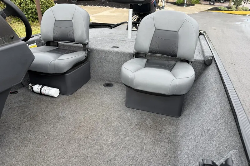 Slide: The Image of 2025 Tracker Bass Tracker Classic XL boat interior with two gray seats and a fire extinguisher. - 15