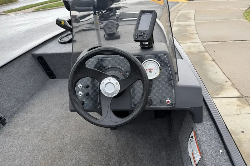 Slide: The Image of 2025 Tracker Bass Tracker Classic XL boat dashboard with steering wheel and navigation display. - 16