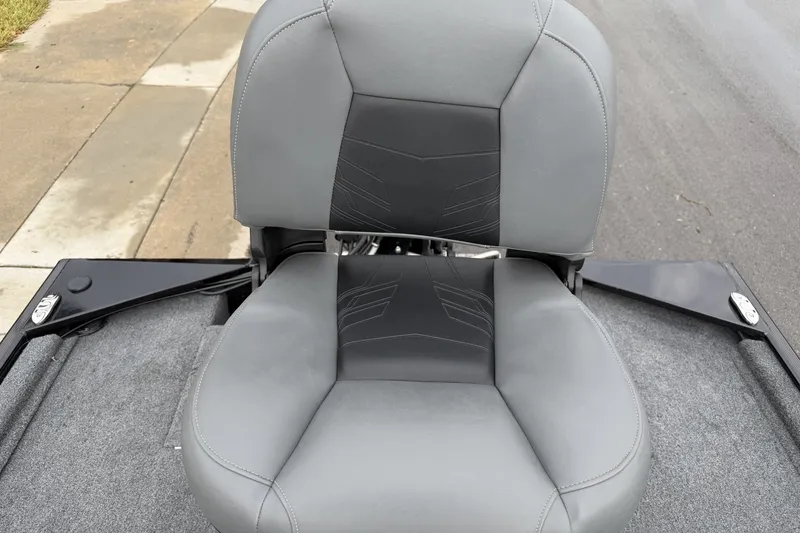 Slide: The Image of 2025 Tracker Bass Tracker Classic XL boat seat, gray upholstery, on a paved surface. - 19