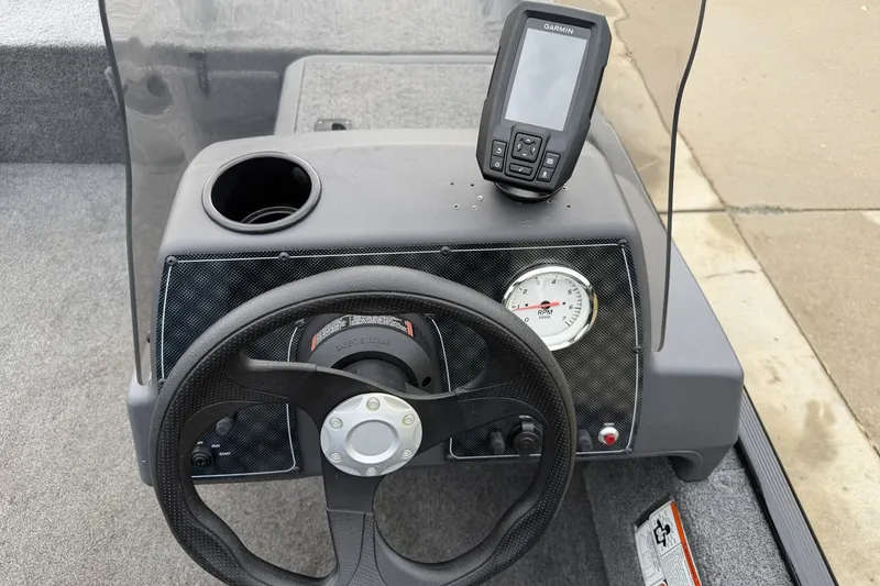 Slide: The Image of 2025 Tracker Bass Tracker Classic XL dashboard with steering wheel and Garmin GPS device. - 17