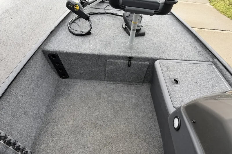 Slide: The Image of 2025 Tracker Bass Tracker Classic XL boat interior with carpeted deck and seating. - 14