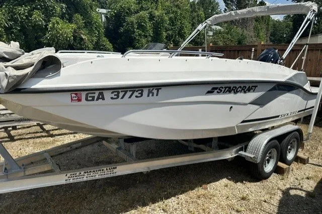 The Image of 2022 Starcraft SVX 191 OB boat on trailer, side view, outdoors. - 15