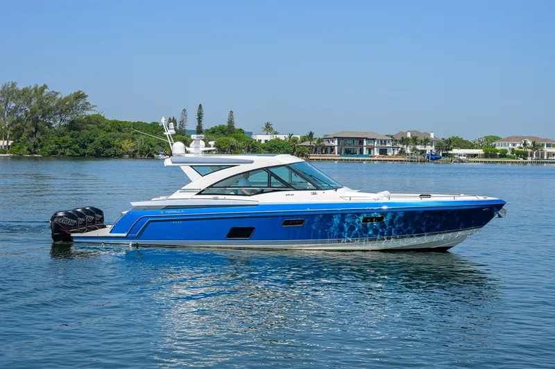 Slide: The Image of 2019 Formula 430 Super Sport Crossover boat cruising on a calm lake. - 52