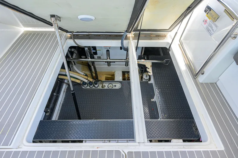 Slide: The Image of Engine compartment of 2019 Formula 430 Super Sport Crossover, showcasing mechanical components and storage. - 27