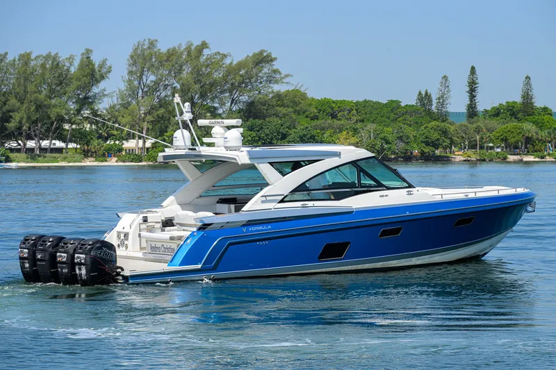 Slide: The Image of 2019 Formula 430 Super Sport Crossover boat cruising on a serene waterway. - 66