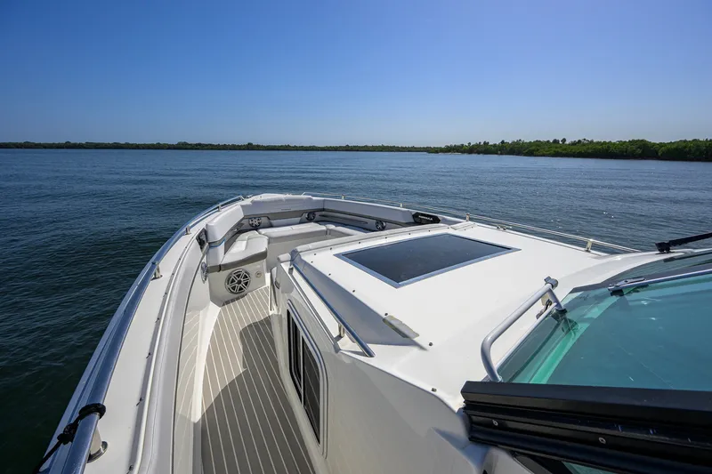 Slide: The Image of 2019 Formula 430 Super Sport Crossover boat on calm water, clear sky background. - 41