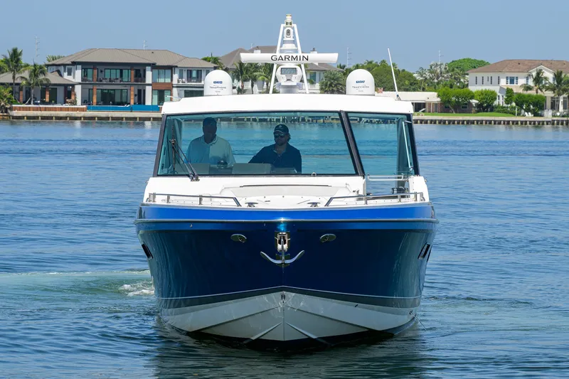 Slide: The Image of 2019 Formula 430 Super Sport Crossover boat cruising on calm water. - 56