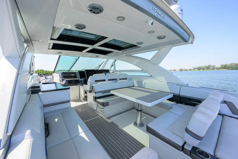 Slide: The Image of Luxurious 2019 Formula 430 Super Sport Crossover yacht interior with seating and table, overlooking water. - 21