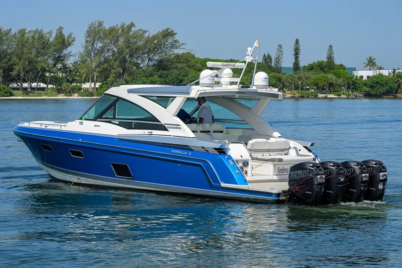 Slide: The Image of 2019 Formula 430 Super Sport Crossover boat cruising on a serene lake. - 62