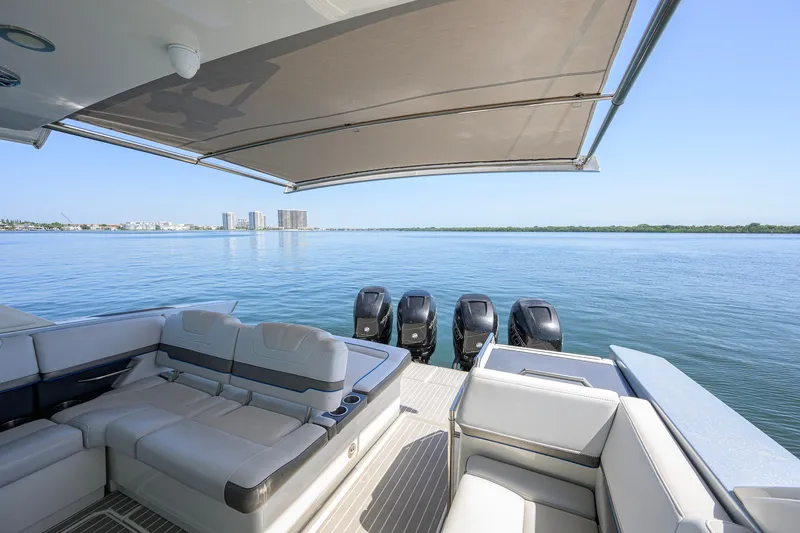 Slide: The Image of Luxury seating on 2019 Formula 430 Super Sport Crossover yacht, overlooking serene waters. - 26