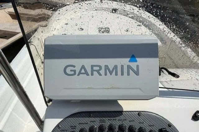 Slide: The Image of Garmin device on 2011 Carolina Skiff JVX18CC boat dashboard, with water droplets. - 17