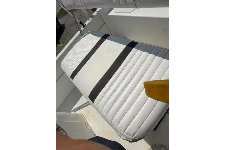 Slide: The Image of 2011 Carolina Skiff JVX18CC boat seat with striped upholstery in white and black. - 19