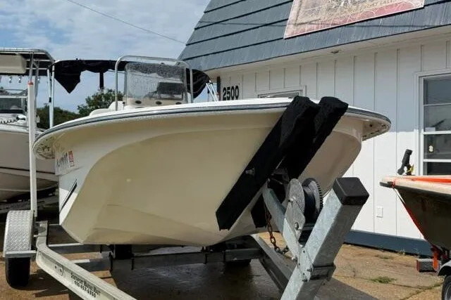Slide: The Image of 2011 Carolina Skiff JVX18CC boat on trailer, parked outside a building. - 2