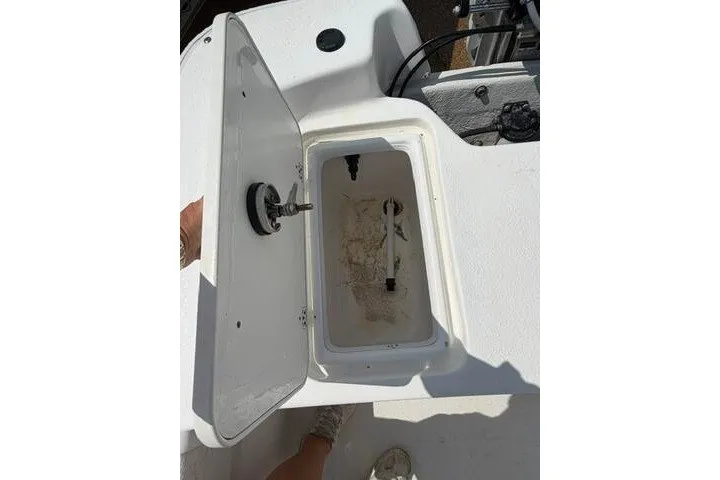 Slide: The Image of Open storage compartment on a 2011 Carolina Skiff JVX18CC boat. - 18