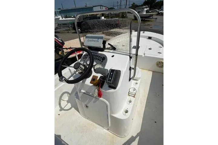 Slide: The Image of 2011 Carolina Skiff JVX18CC boat console with steering wheel and Garmin navigation system. - 16