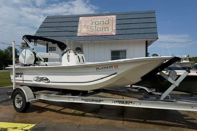 Slide: The Image of 2011 Carolina Skiff JVX18CC boat on trailer, parked outside a building. - 1