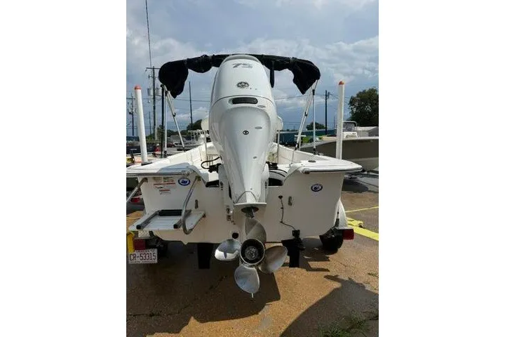 Slide: The Image of 2011 Carolina Skiff JVX18CC boat with outboard motor, parked on a trailer. - 4