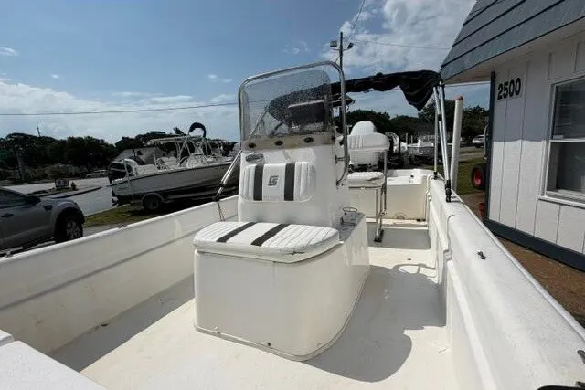 Slide: The Image of 2011 Carolina Skiff JVX18CC boat with center console and seating, parked outdoors. - 9