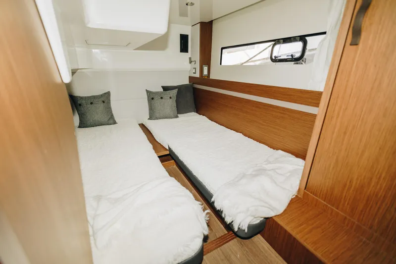 Slide: The Image of Interior cabin of 2026 Beneteau Antares 12 Fly with twin beds and wooden finish. - 16