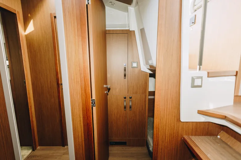 Slide: The Image of Interior of 2026 Beneteau Antares 12 Fly, featuring elegant wood paneling and modern design. - 15