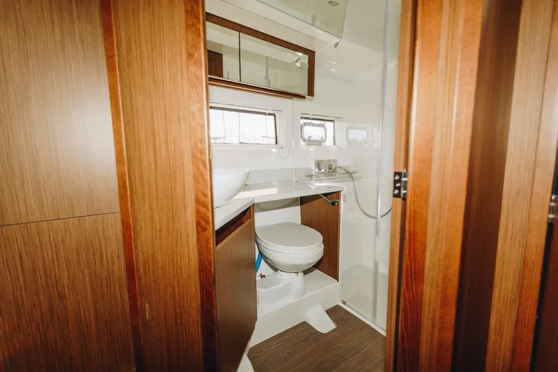 Slide: The Image of Luxurious bathroom interior of 2026 Beneteau Antares 12 Fly yacht with wood accents. - 19