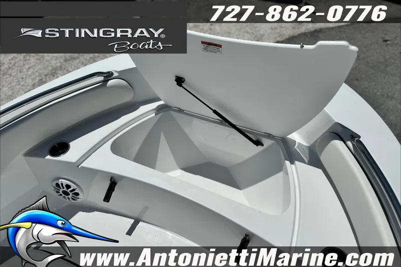 Slide: The Image of 2027 Stingray 17 CC boat interior with open storage compartment, speaker, and website details. - 13