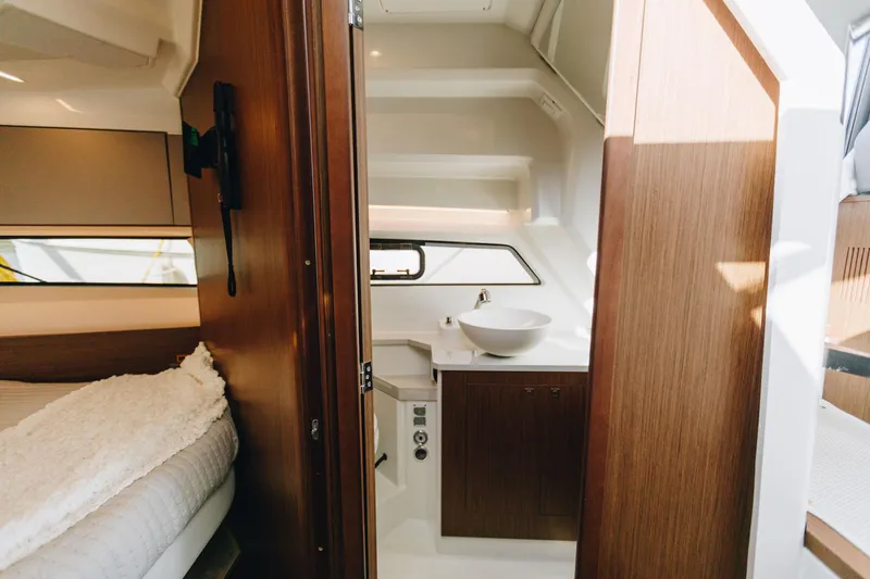 Slide: The Image of Interior of 2026 Beneteau Antares 9, featuring a modern bathroom with wood accents. - 18