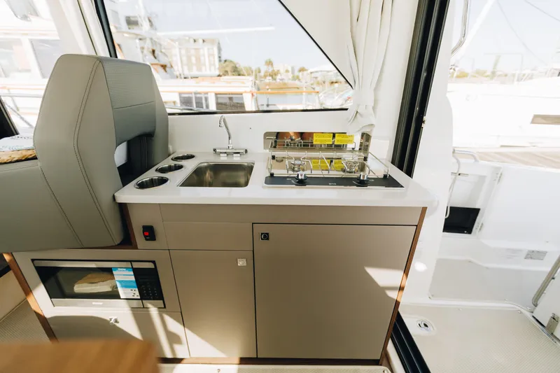 Slide: The Image of Interior view of 2026 Beneteau Antares 9 yacht kitchen with stove and sink. - 16