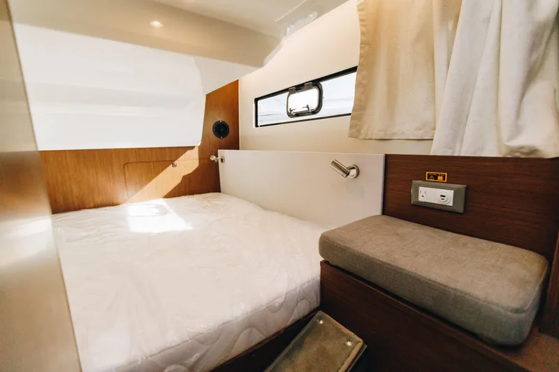 Slide: The Image of Interior cabin of 2026 Beneteau Antares 9 with bed and window. - 20