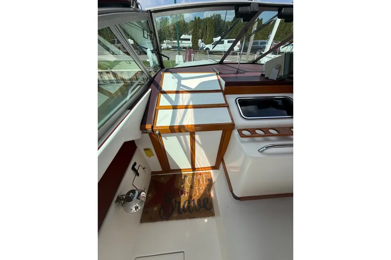 Slide: The Image of 1989 Sea Ray 340 Sundancer cockpit with wooden accents and outdoor sink. - 18