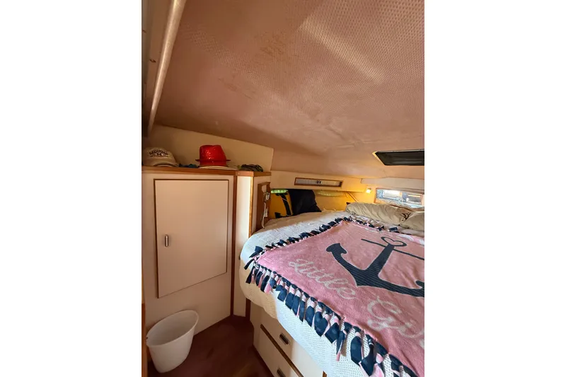 Slide: The Image of Cozy cabin interior of 1989 Sea Ray 340 Sundancer with nautical-themed decor. - 25