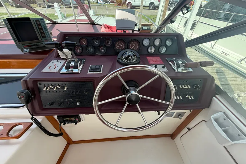 Slide: The Image of 1989 Sea Ray 340 Sundancer helm with steering wheel, gauges, and controls. - 17