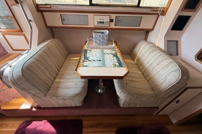 Slide: The Image of Interior of 1989 Sea Ray 340 Sundancer with cozy dining area and patterned table. - 20