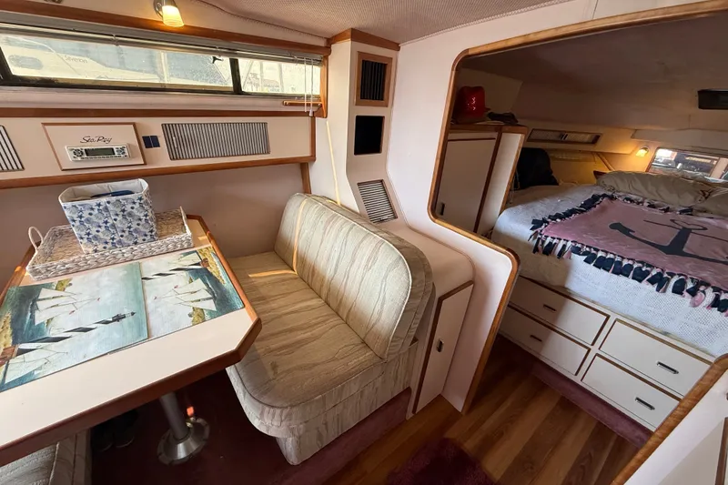 Slide: The Image of Interior of 1989 Sea Ray 340 Sundancer with cozy seating and sleeping area. - 22