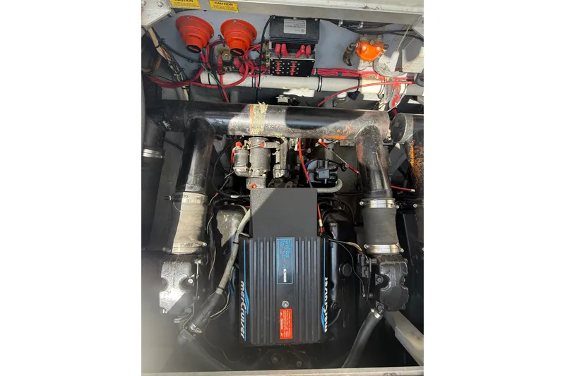 Slide: The Image of Engine compartment of a 1989 Sea Ray 340 Sundancer, featuring a MerCruiser engine. - 35