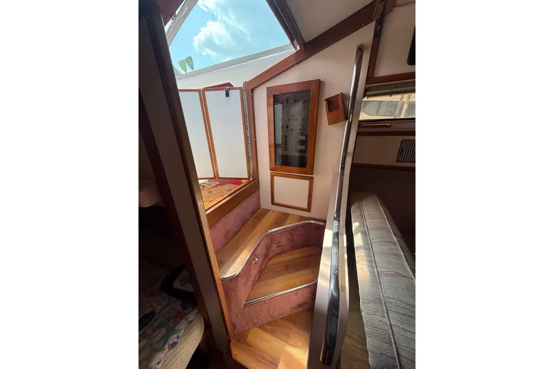 Slide: The Image of Interior view of 1989 Sea Ray 340 Sundancer boat with wooden steps and skylight. - 31