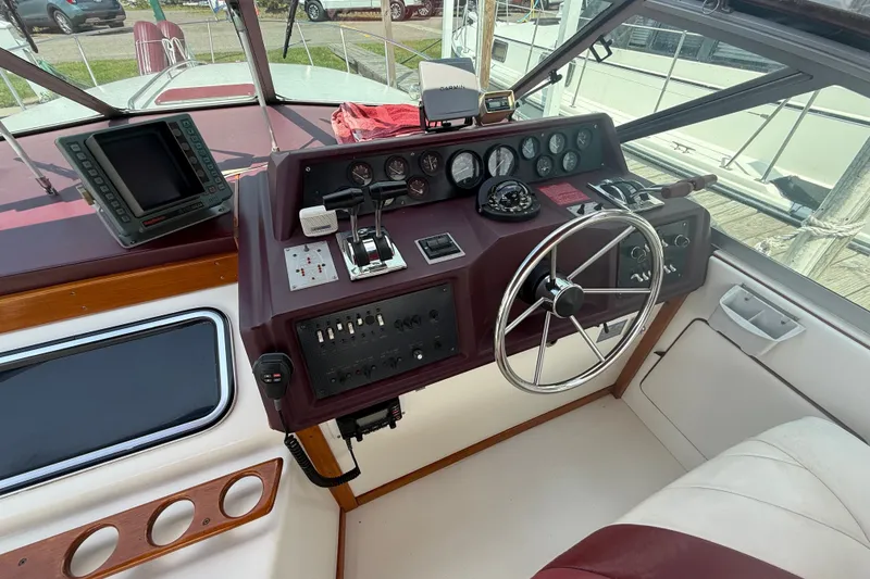 Slide: The Image of Cockpit of 1989 Sea Ray 340 Sundancer with steering wheel and navigation instruments. - 16