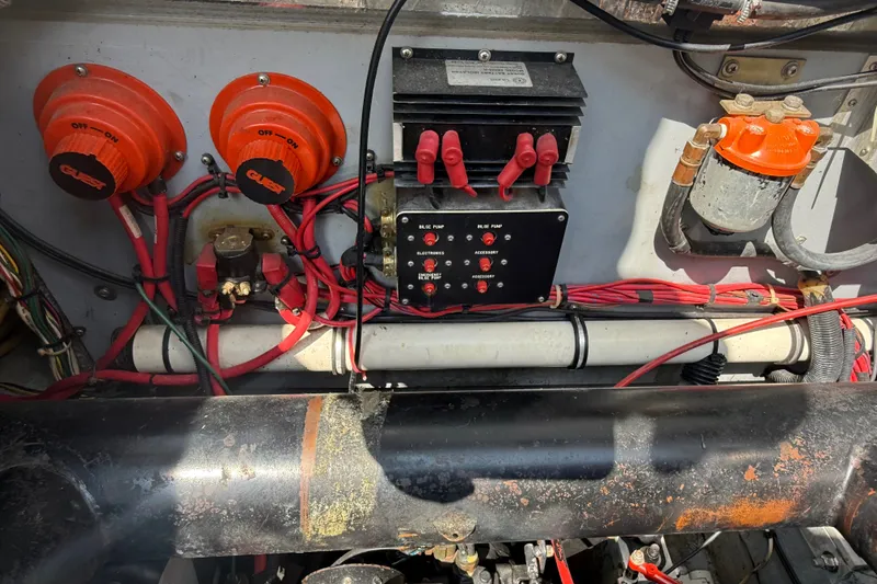 Slide: The Image of Engine compartment of a 1989 Sea Ray 340 Sundancer with wiring and switches visible. - 36