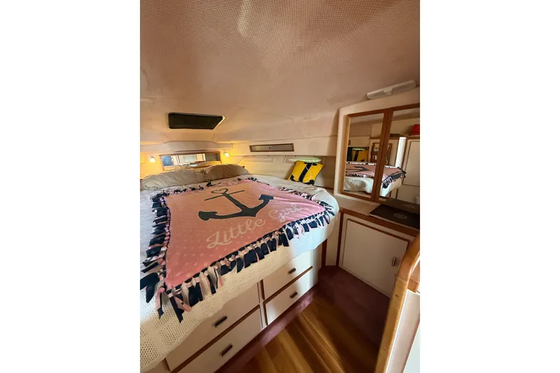 Slide: The Image of Cozy cabin interior of 1989 Sea Ray 340 Sundancer with nautical-themed decor. - 24
