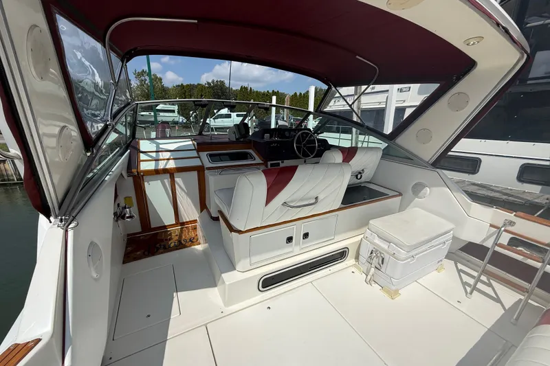 Slide: The Image of Interior view of a 1989 Sea Ray 340 Sundancer boat with white and red seating. - 11