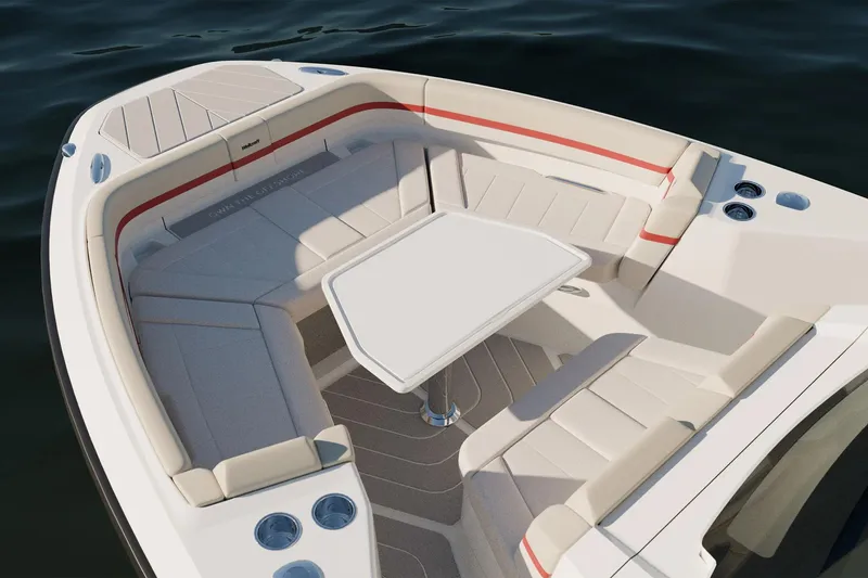 Slide: The Image of 2026 Wellcraft 28 T-Top boat interior with seating and table on calm water. - 21