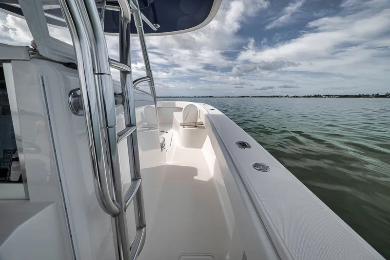 Slide: The Image of 2016 Bahama 41 boat on calm water under a partly cloudy sky. - 25