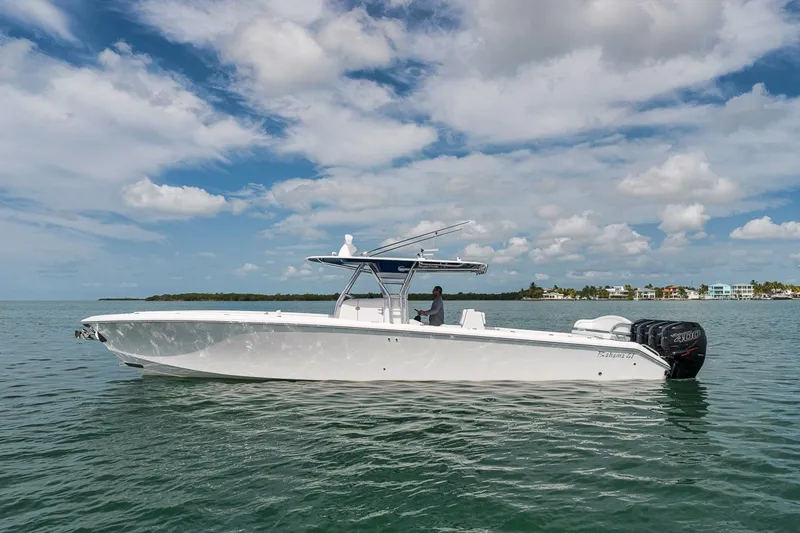 The Image of 2016 Bahama 41 boat on calm water under a partly cloudy sky. - 0