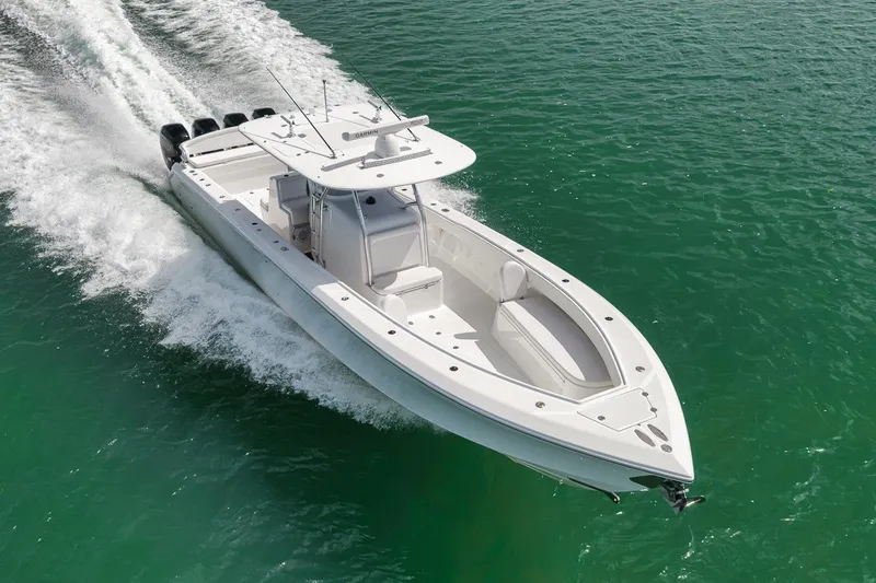 Slide: The Image of 2016 Bahama 41 boat cruising on clear turquoise water. - 4
