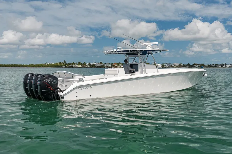 Slide: The Image of 2016 Bahama 41 boat on calm water, featuring multiple powerful outboard engines. - 2