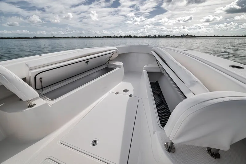 Slide: The Image of 2016 Bahama 41 boat interior with open storage compartments, calm water, and cloudy sky. - 35