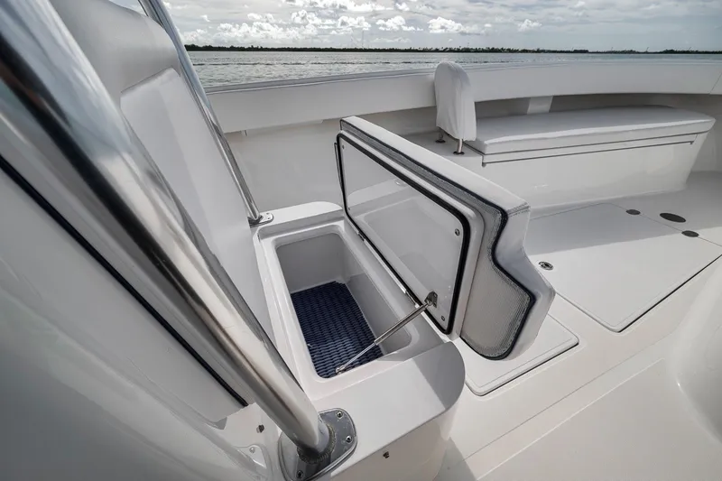 Slide: The Image of 2016 Bahama 41 boat with open storage compartment on deck, near water. - 30