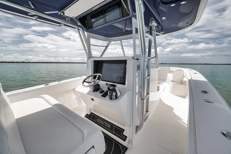 Slide: The Image of 2016 Bahama 41 boat interior with modern helm, open water view. - 9