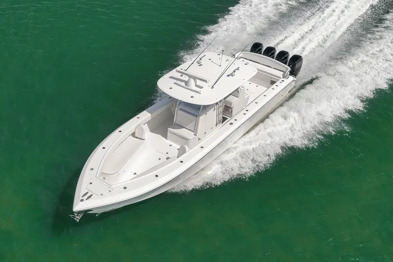 Slide: The Image of 2016 Bahama 41 boat cruising on clear green water, aerial view. - 5
